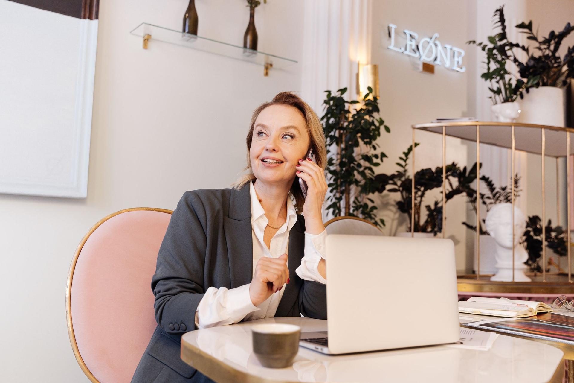 An agent on a call at her laptop, smiling